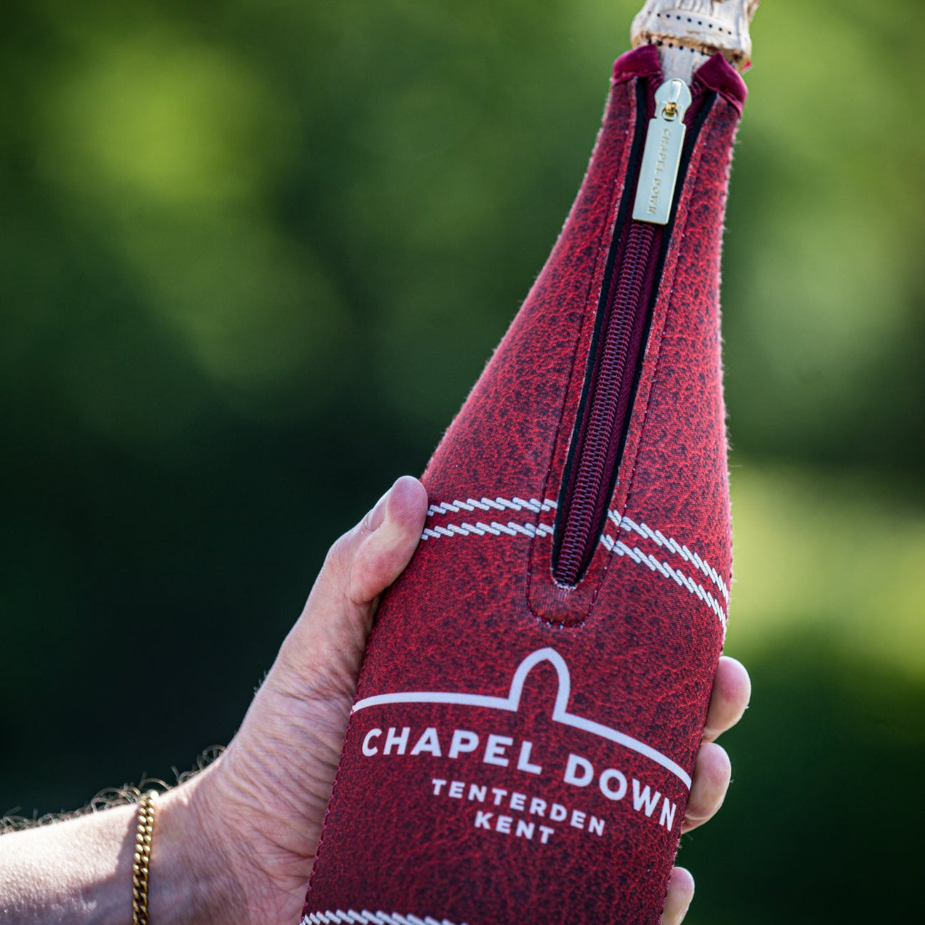 A bottle of Chapel Down sparkling wine in a branded cooler sleeve
