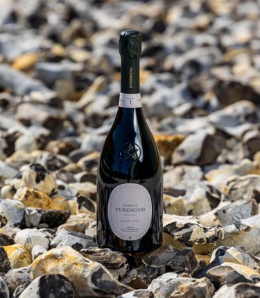 A bottle of Domaine Evremond Classic Cuvée on a bed of oyster shells